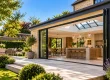 Luxury stone house extension with modern open-plan kitchen, bi-fold doors and landscaped garden in Oxfordshire