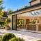 Luxury stone house extension with modern open-plan kitchen, bi-fold doors and landscaped garden in Oxfordshire